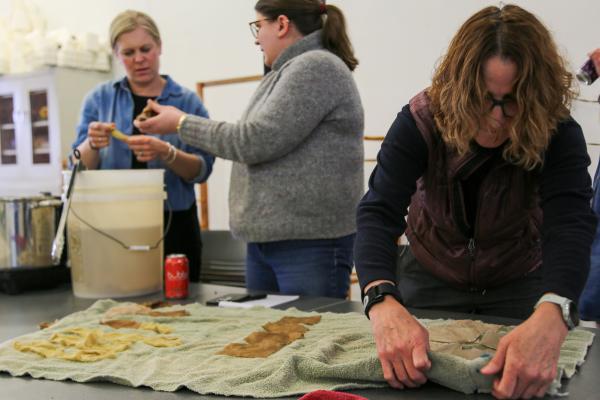 Participants demonstrate natural dyeing in the workshop. Photo by Haley Simpkins.