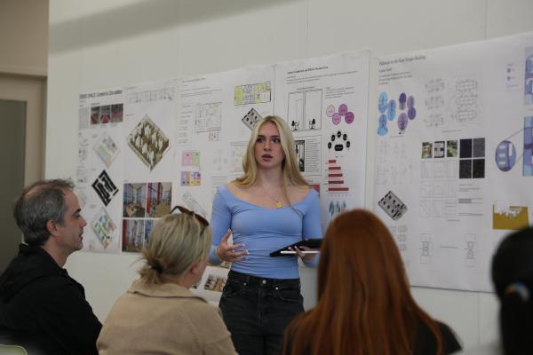 In:Access Studio student Sydney Weibl presents her recommendations on how to make pathways in the Gray Design Building more accessible to an audience of peers, faculty and professionals during final reviews. Photo by Haley Simpkins.