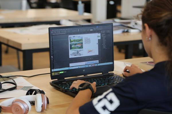 PRD student Aubree Hay designs materials for the Trimble County project on her computer. 