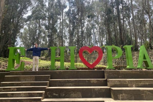 Kauner Shacklette poses as the T in an interactive ETHIOPIA sign photo opp at Entoto Park.