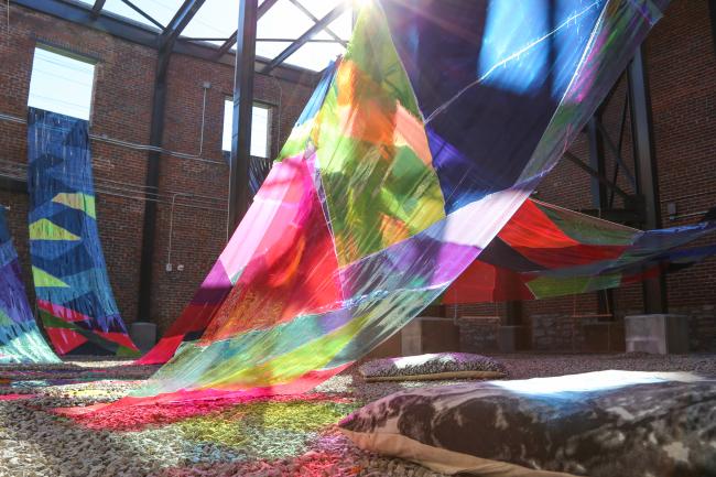 Installed in the Gray Design Building’s Maker Yard, “Falling Color” is a vibrant homage to the concealed creek running underfoot and the historical layers of Lexington that lie beneath the surface. Photo by Haley Simpkins.