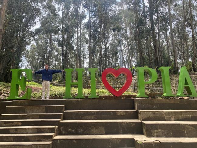 Kauner Shacklette poses as the T in an interactive ETHIOPIA sign photo opp at Entoto Park.