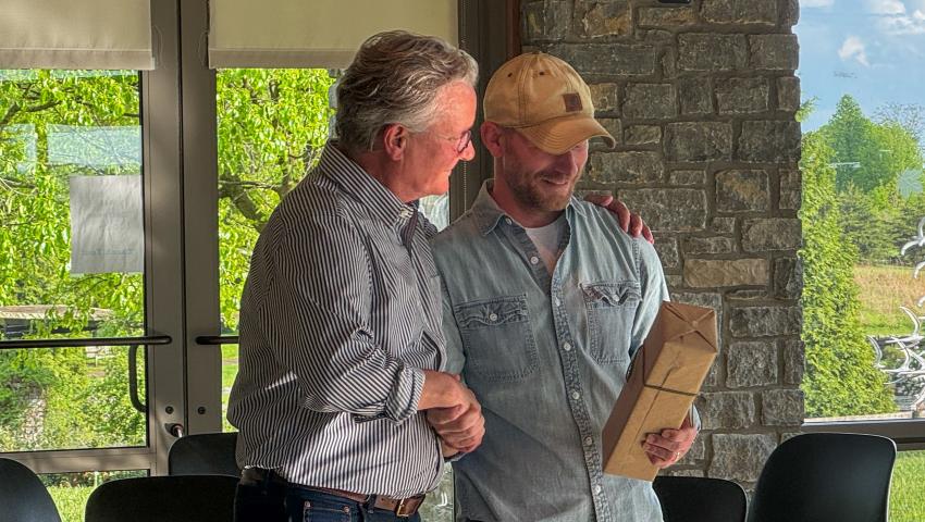 Jon Mills shakes Dean Ned Crankshaw's hand as he receives a special honor.